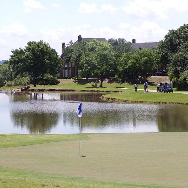 golf green with water hazard/pond in the background